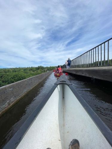 People canoeing across the Pontcysyllte Aqueduct