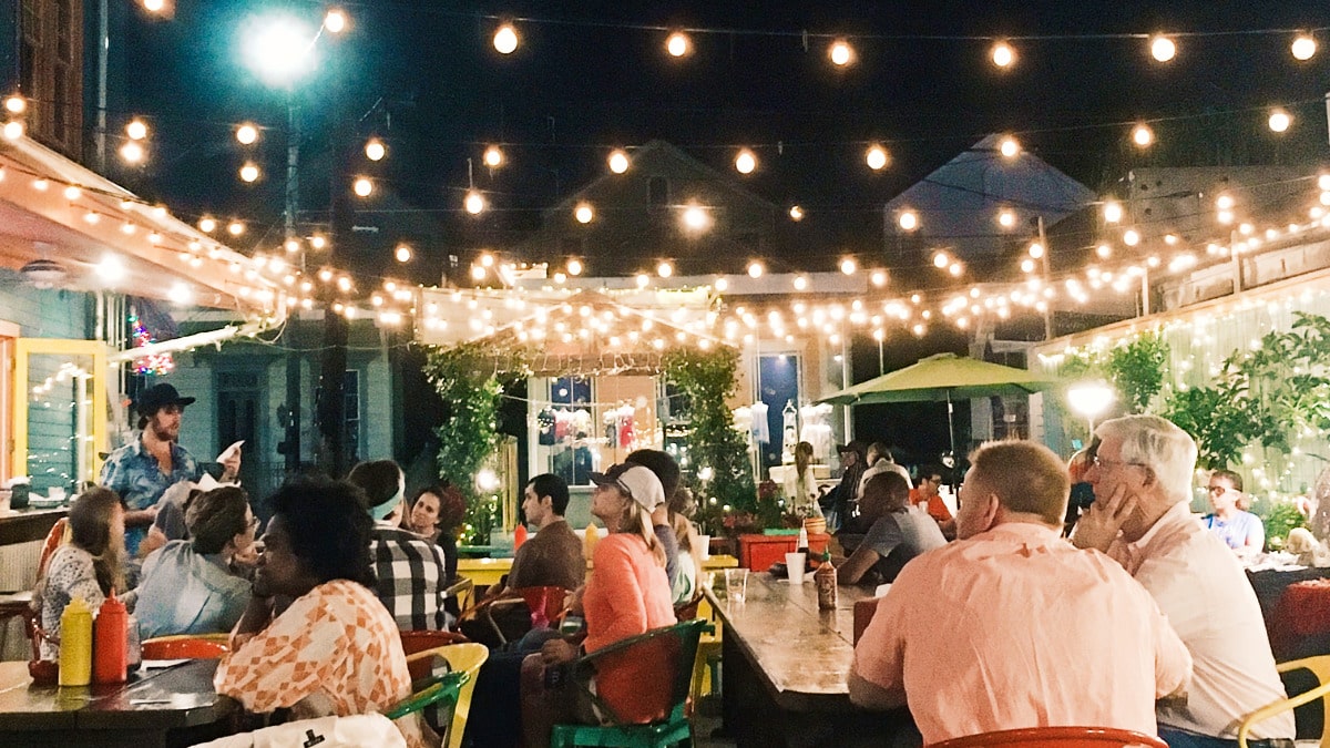 View of the people dining outside the Dat Dog at night