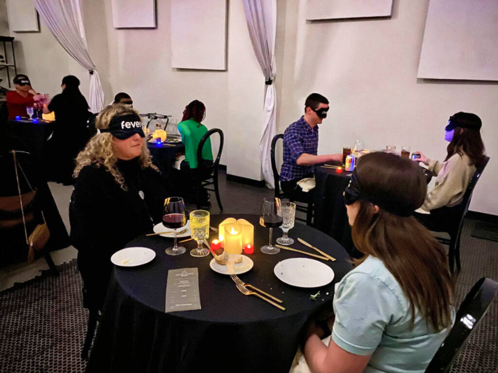 The people at a dining area with blindfolds