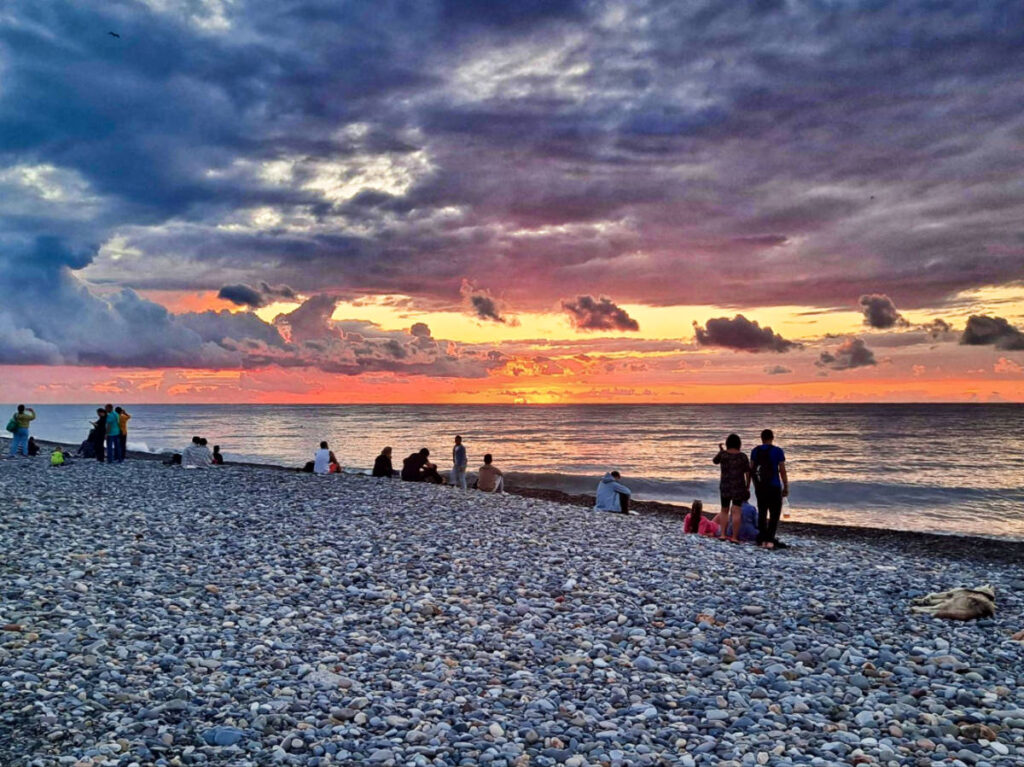 View of the people watching the sunset at the beach