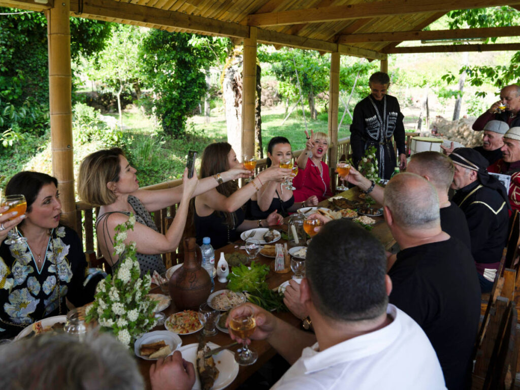 A group of people on a table having a toast with their glasses