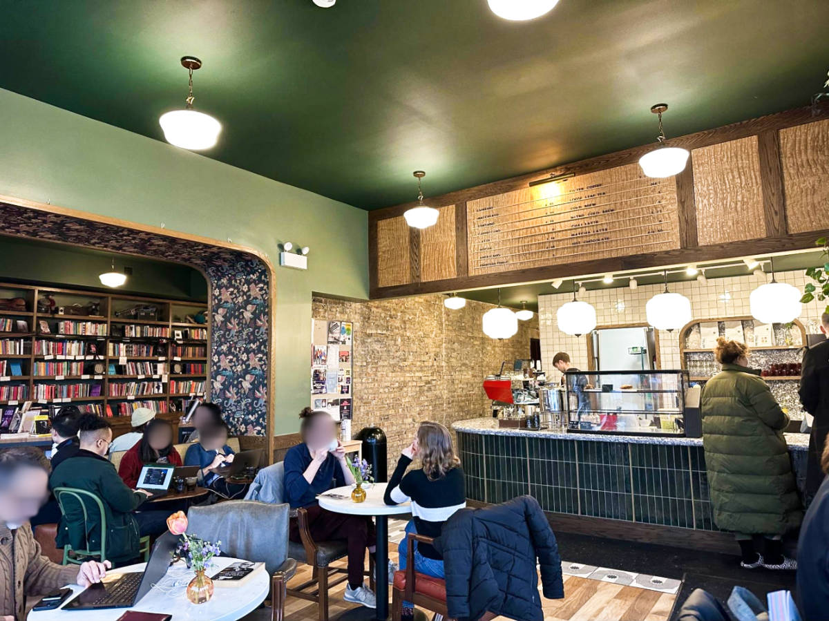 View of the people chilling inside the cozy interior of The Understudy Coffee and Books