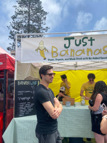 People lining up in front of a stall selling frozen banana yogurt