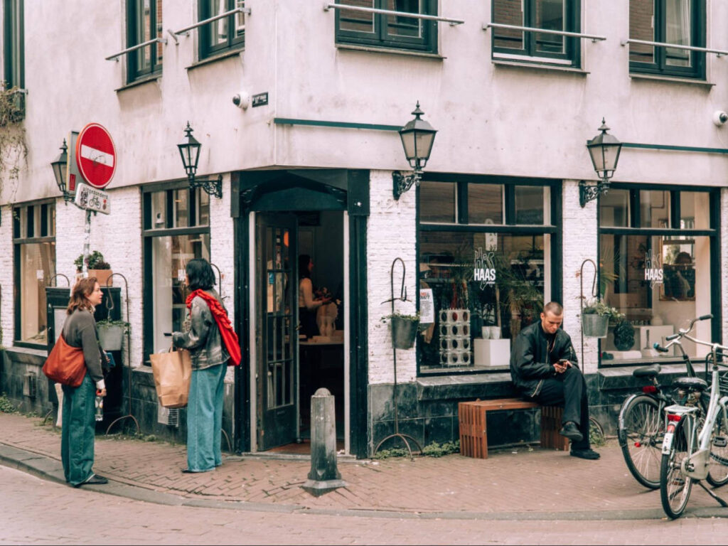 Exterior view of the restaurant with an uneven pavement and the people enjoying outside