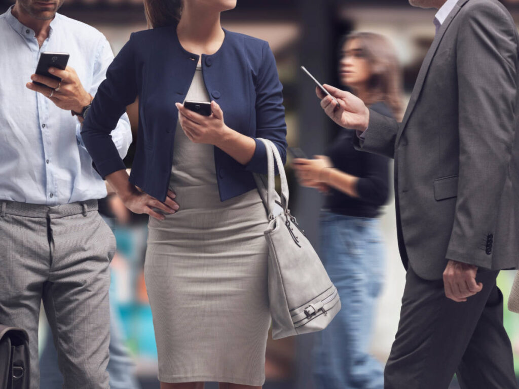 People walking around while using their phone