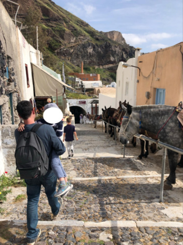 A family walking down to the port in Santorini