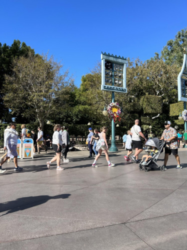 Clear blue sky over people wandering in Disneyland Park