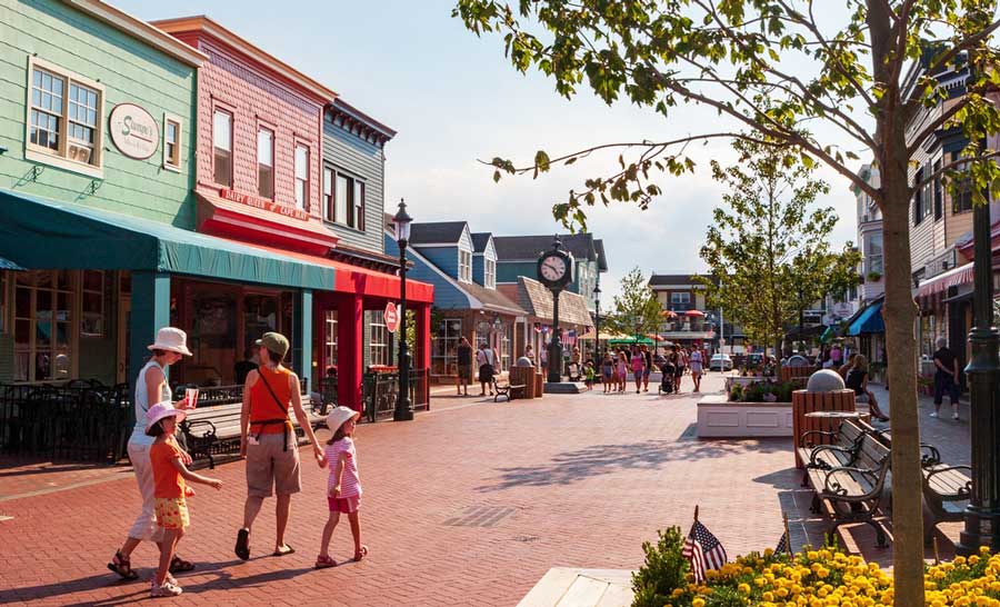 People walking along the colorful shops of Washington Street Mall