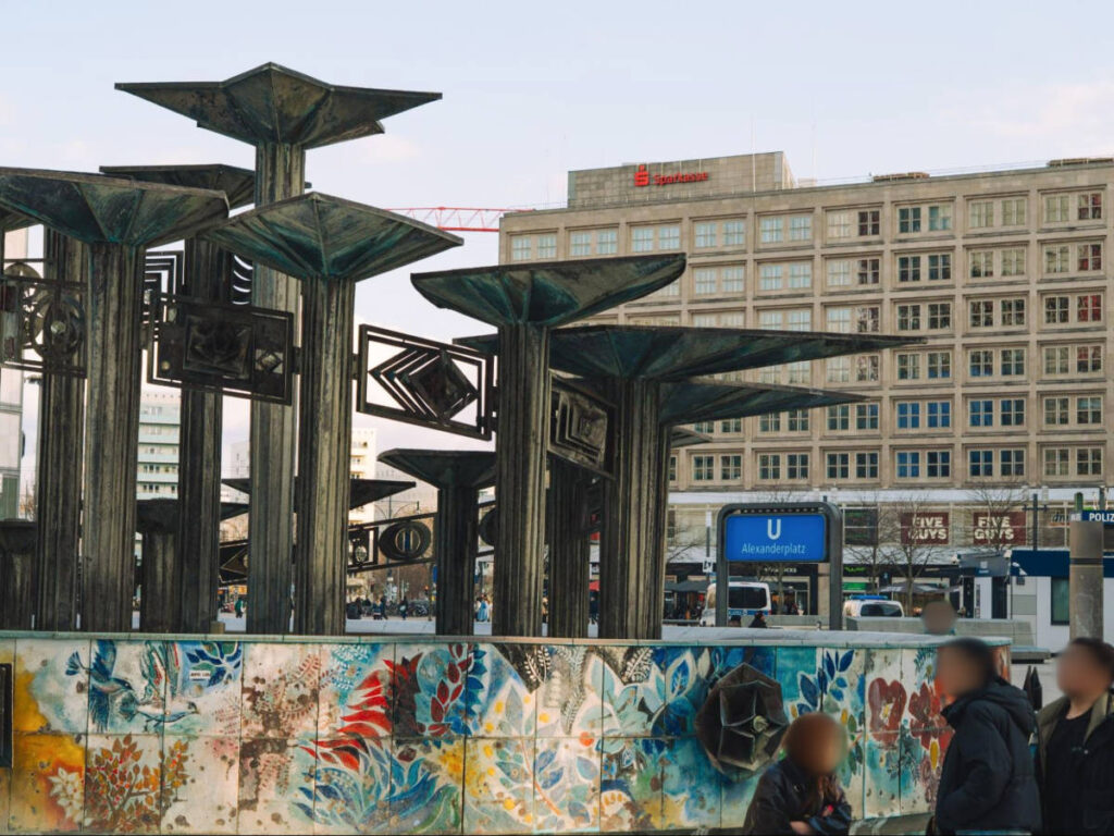 People admiring the colorful wall at the Alexanderplatz 