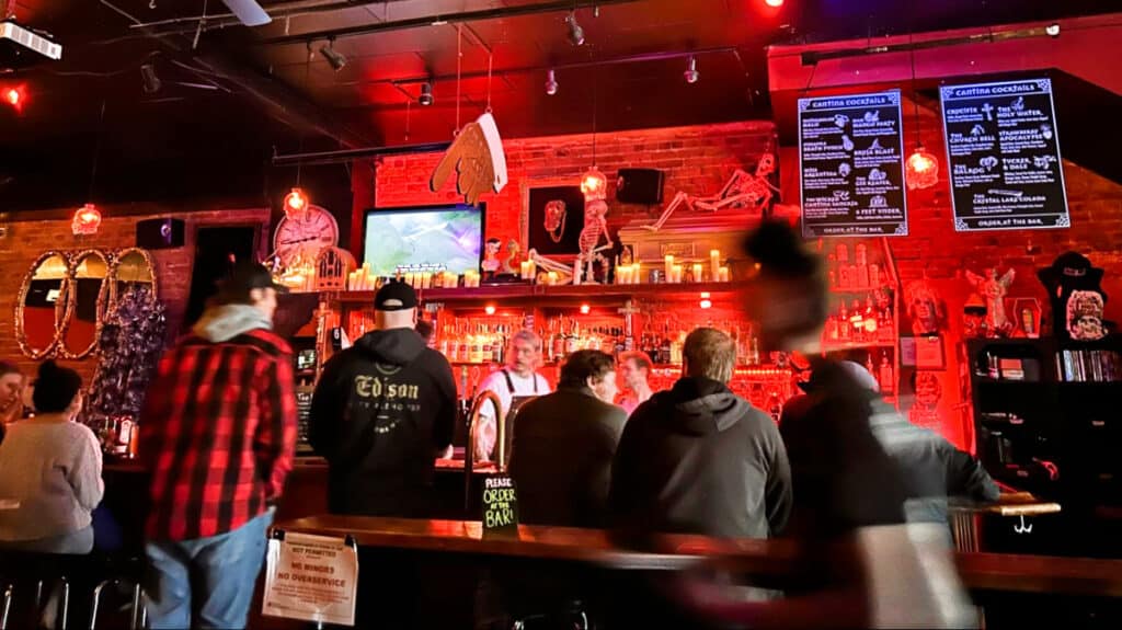 View of the people inside the busy bar counter of The Church Cantina