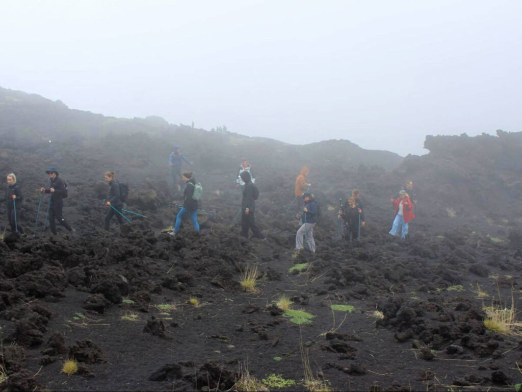 People walking through lava fields