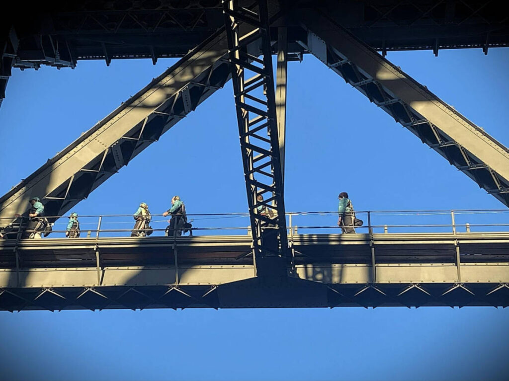 People walking along the  Sydney Harbour Bridge