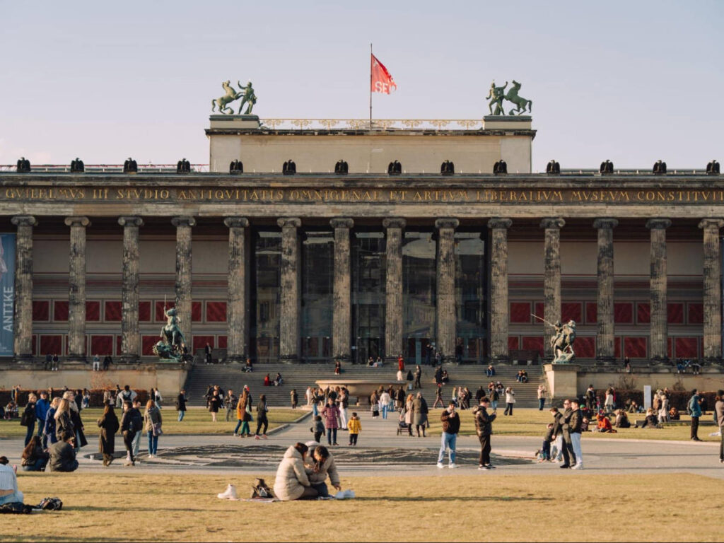 People relaxing in front of the Altes Museum on a sunny day