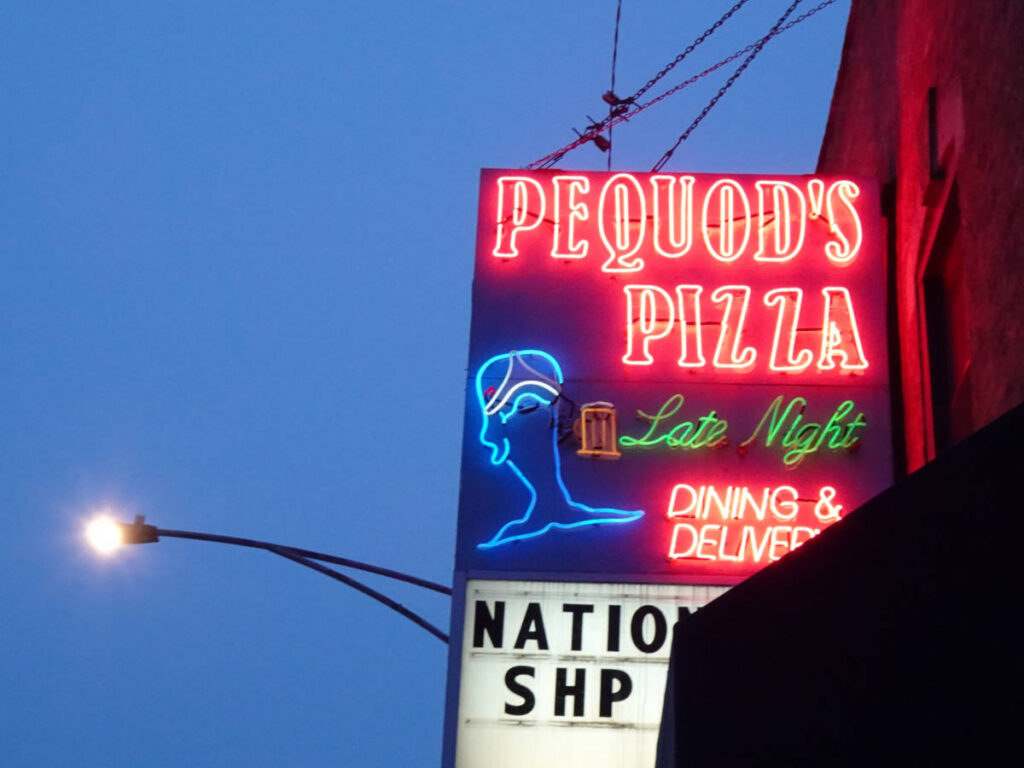 The neon signage of Pequod’s Pizza