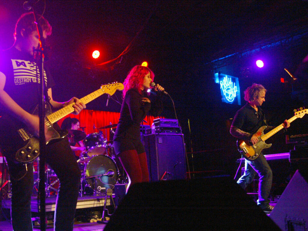 A band performing on the stage at Belly Up Tavern