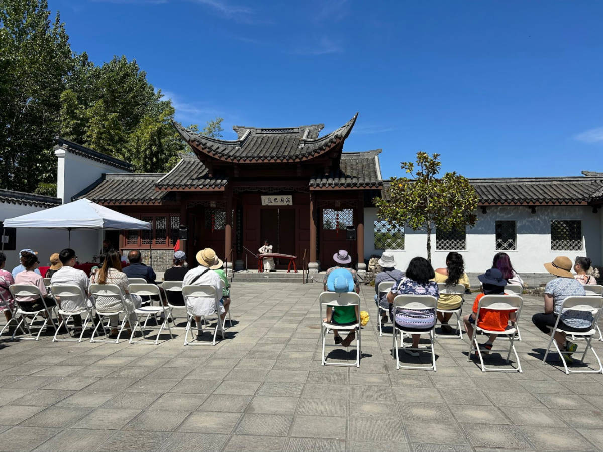 People watching a traditional performance at the Chinese Garden