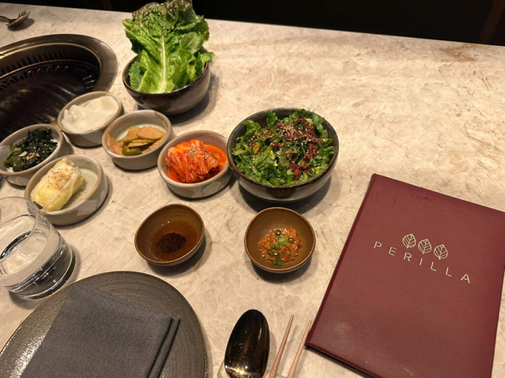 Korean BBQ side dishes served in Perilla