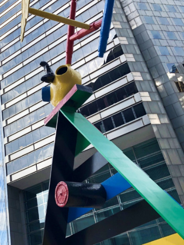 View of the Personage and Birds sculpture by Joan Miro outside the building