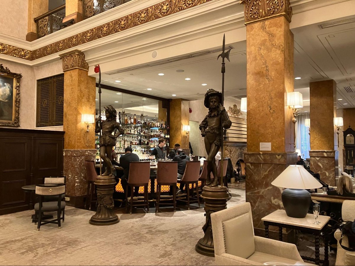 People enjoying a drink at the Pfister hotel lobby bar