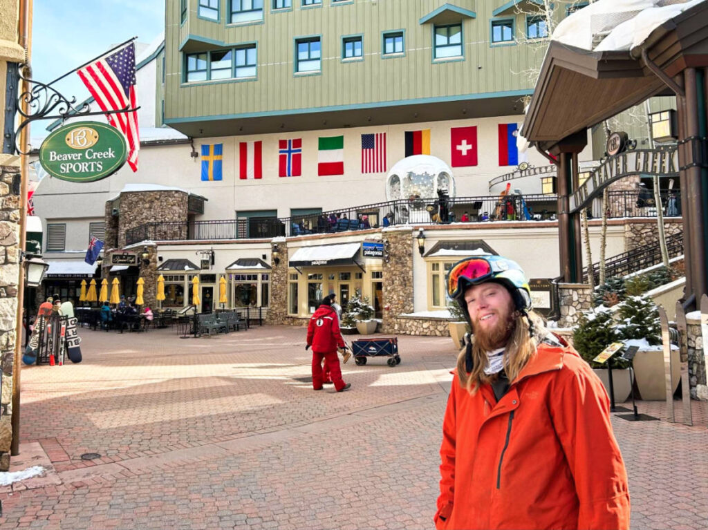 The author Abigail Bliss's husband, posing with the Beaver Creek Village in the background