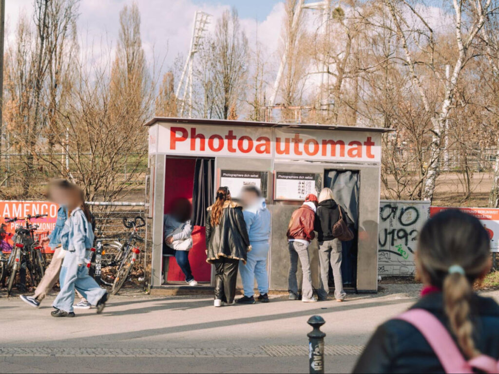 People checking out a photobooth next to Mauerpark