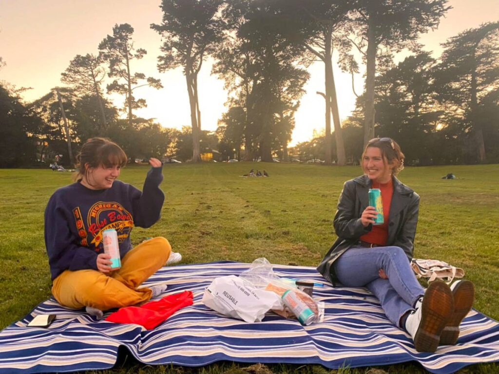 Author Laura and her friend having a picnic at sunset in Golden Gate Park