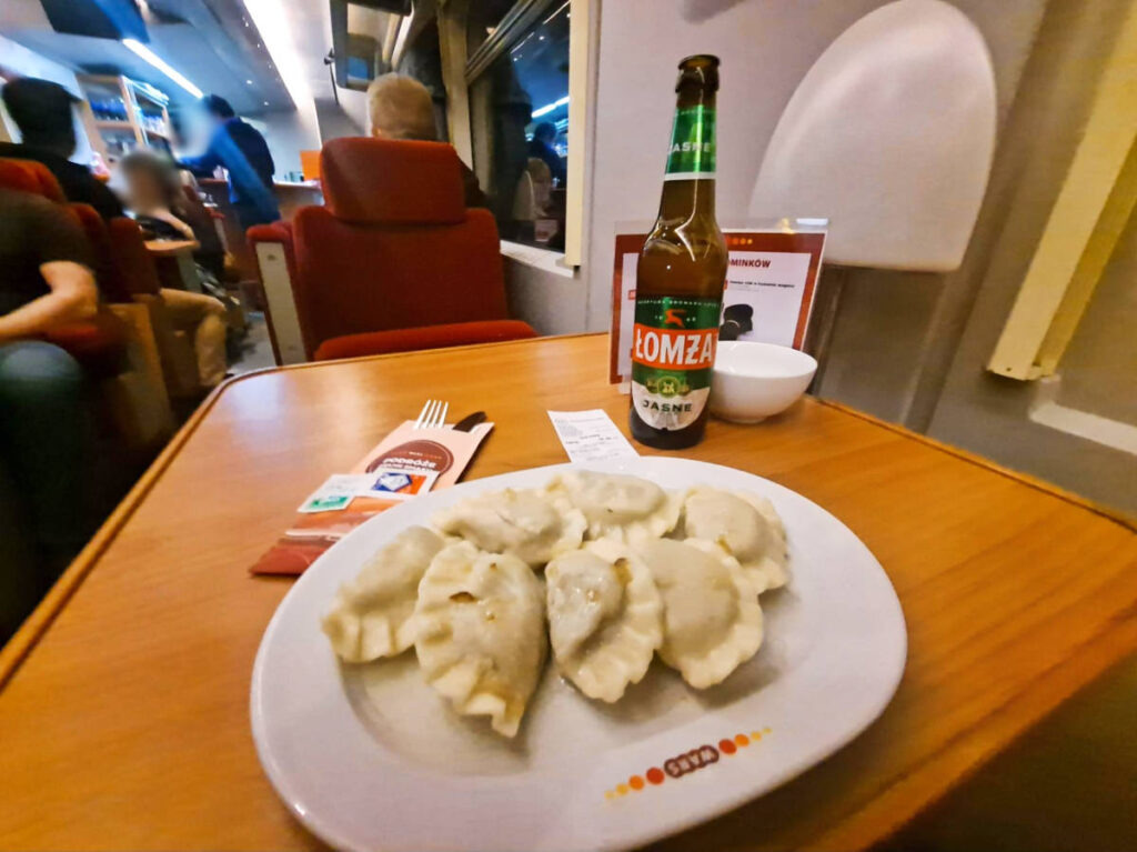 A plate of dumplings and beer on a train ride