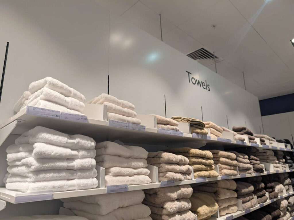 The wash cloths piled on the shelves