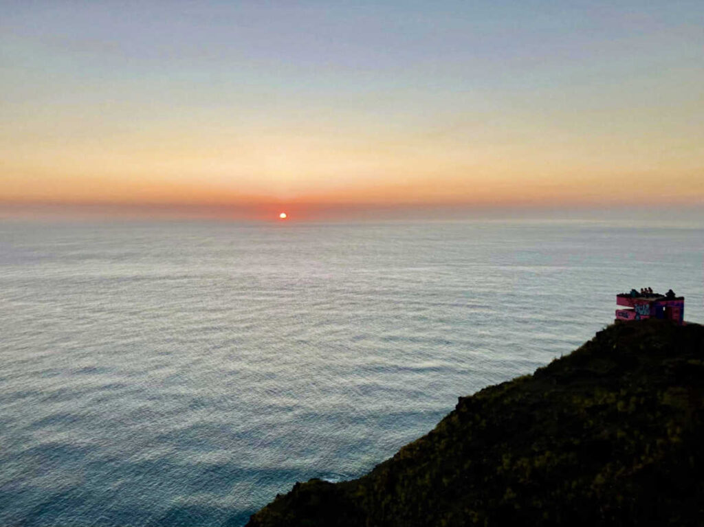 Aerial view of the Pink Pillbox on top of the mountain and the Pacific at sunset