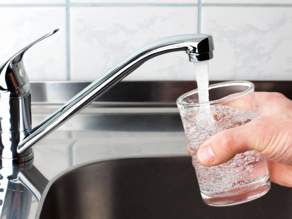 A man getting tap water