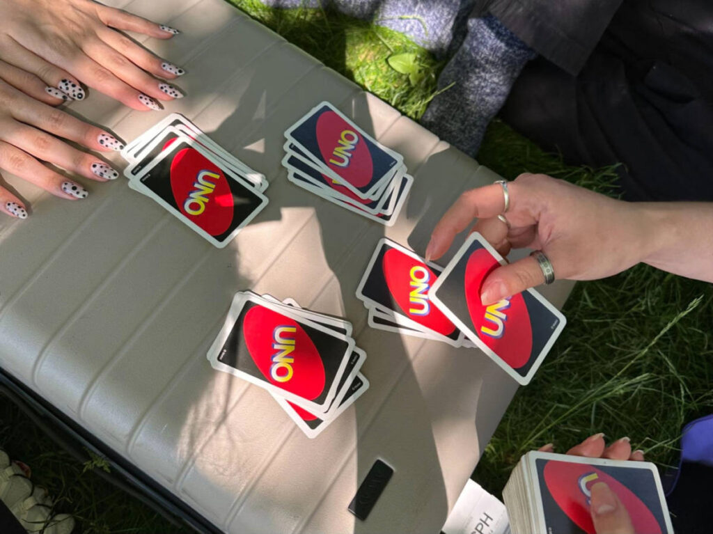 Closeup look of the hands playing UNO cards
