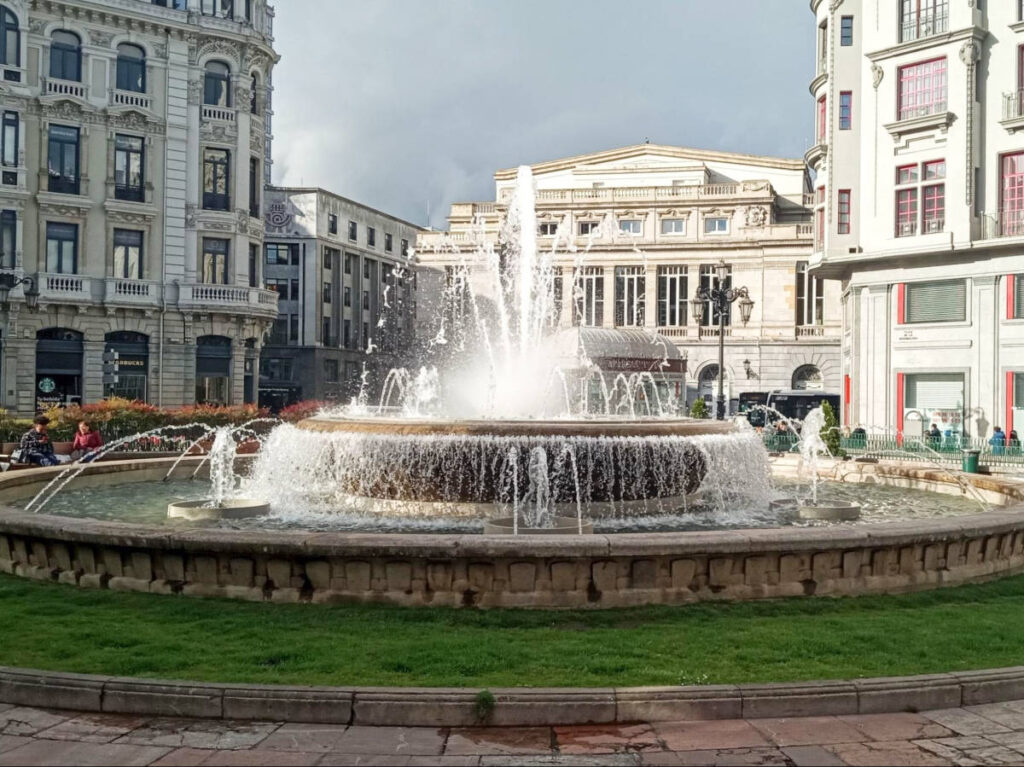 View of the huge fountain at the Plaza de la Escandalera with the Teatro Campoamor in the background