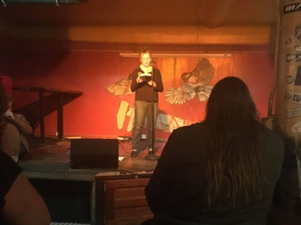 The author's mother, Kathleen Dale, poetry reading at Woodland Pattern bookshop