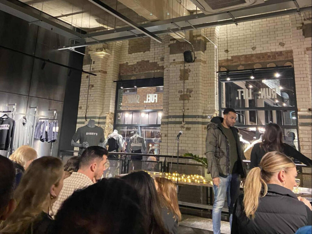 People watching a performance on stage at a Pop up Don’t Tell Comedy show