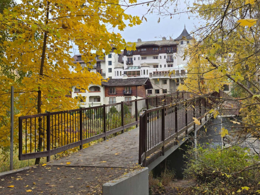 View of the bridge leading to the opulent Posthotel surrounded by fall foliage