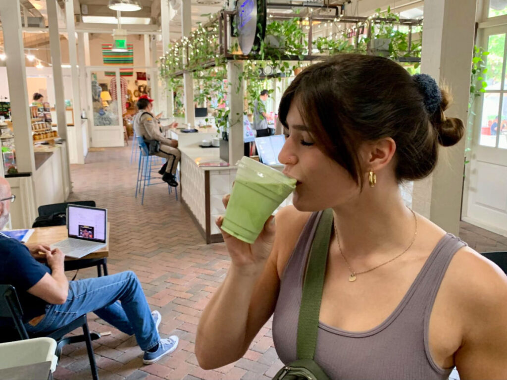 Author Betty sipping a matcha latte at Presta Coffee Roasters