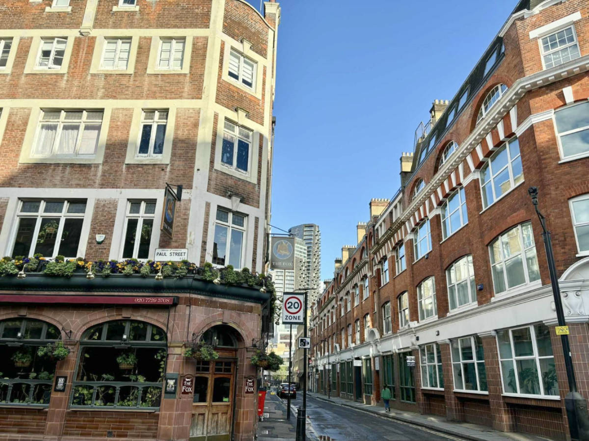 A corner pub nestled in the brick walled buildings at the London Borough of Islington on a sunny day