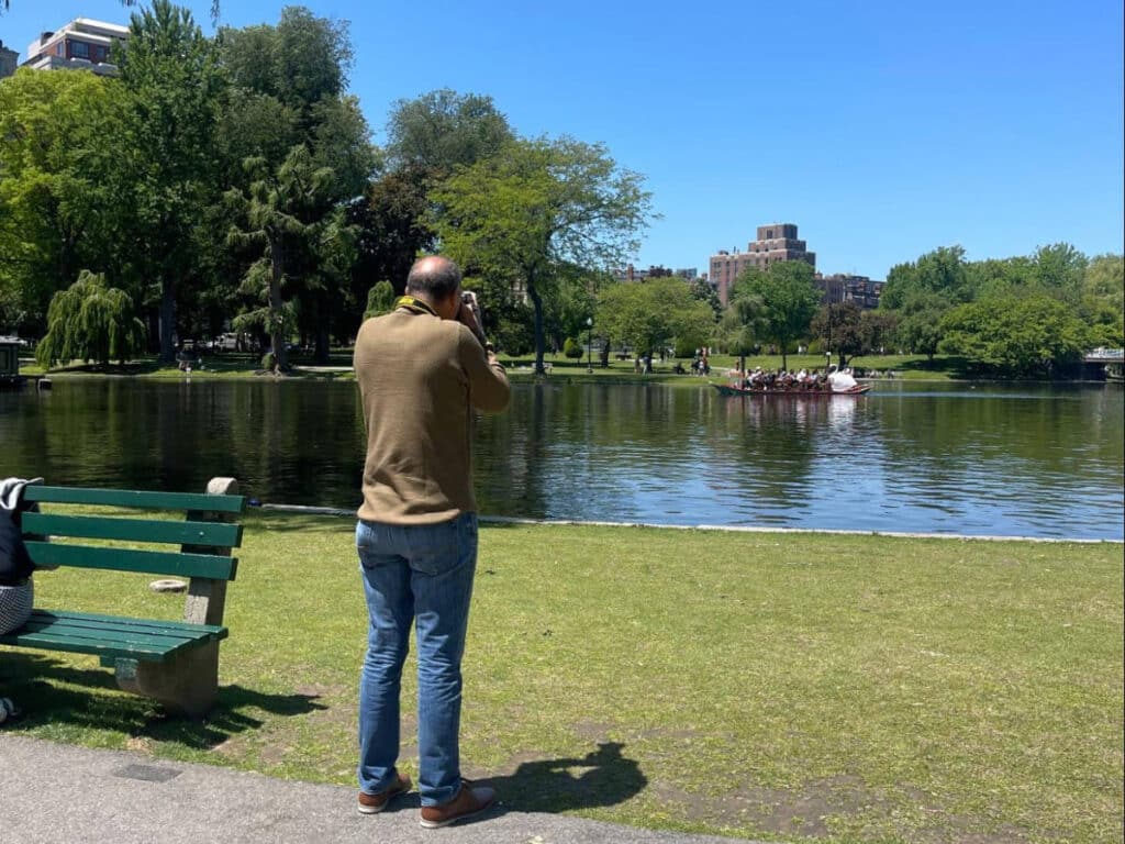 The author's friend taking a photo at the Boston Public Garden