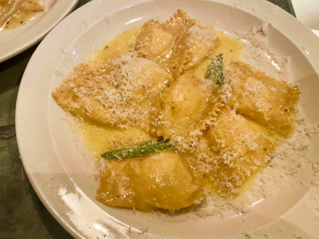 A Pumpkin ravioli with sage butter served on a plate at Padella