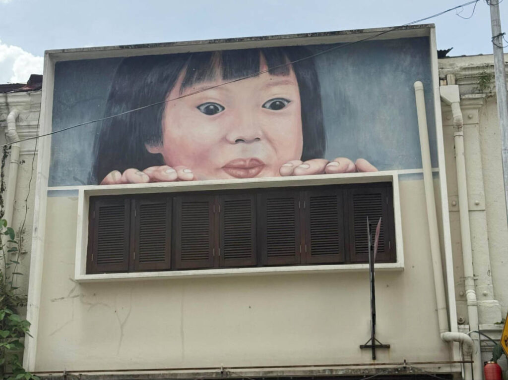 View of the quirky mural on the old building of a shop