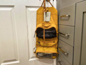 A hanged toiletry bag behind the door