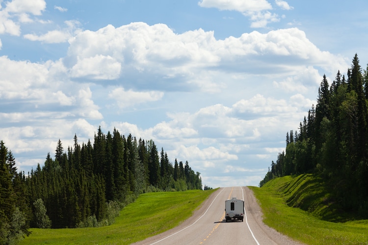 View of a Recreational Vehicle driving on empty road