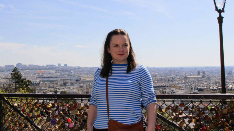 The author, Rachel Kapelke Dale smiling for a photo at Sacré-Coeur in Montmartre