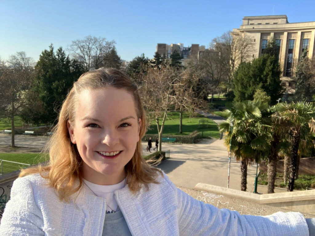 The author, Rachel Kapelke-Dale, smiling for a photo in the Trocadero Gardens