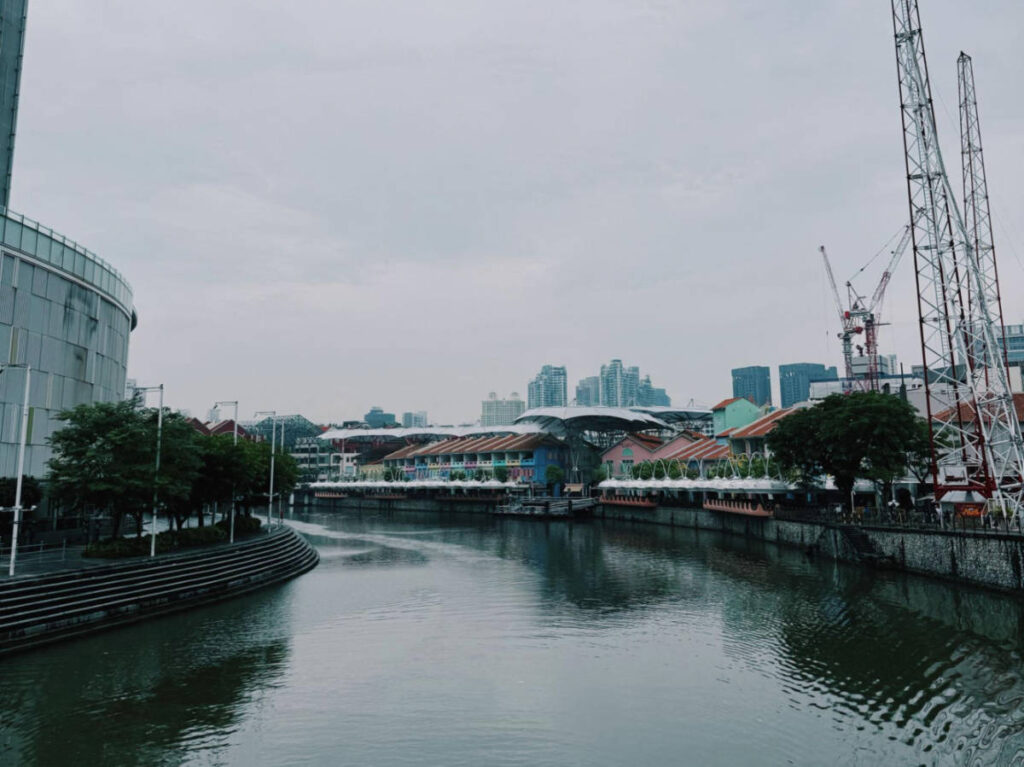 A tranquil river with city buildings around on a rainy afternoon in Singapore