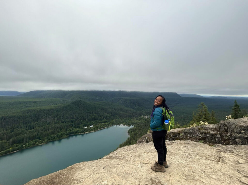 Author Chelsea Booker atop Rattlesnake Ledge Mount Baker Snoqualmie National Forest on a cloudy day