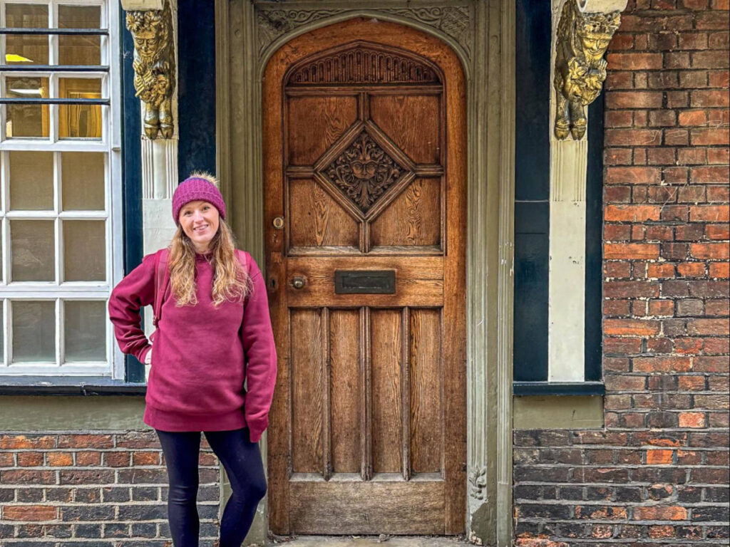 The author Rebecca Rayner, posing for a photo in front of the The Narnia Door