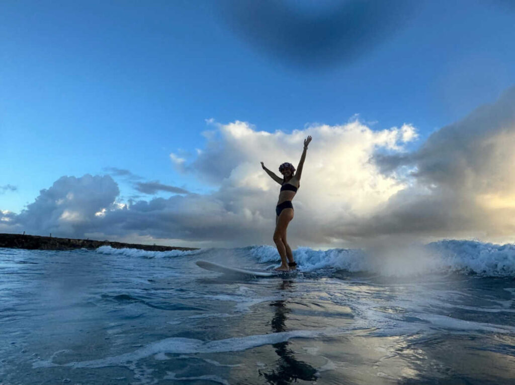 A woman surfing at Oahu