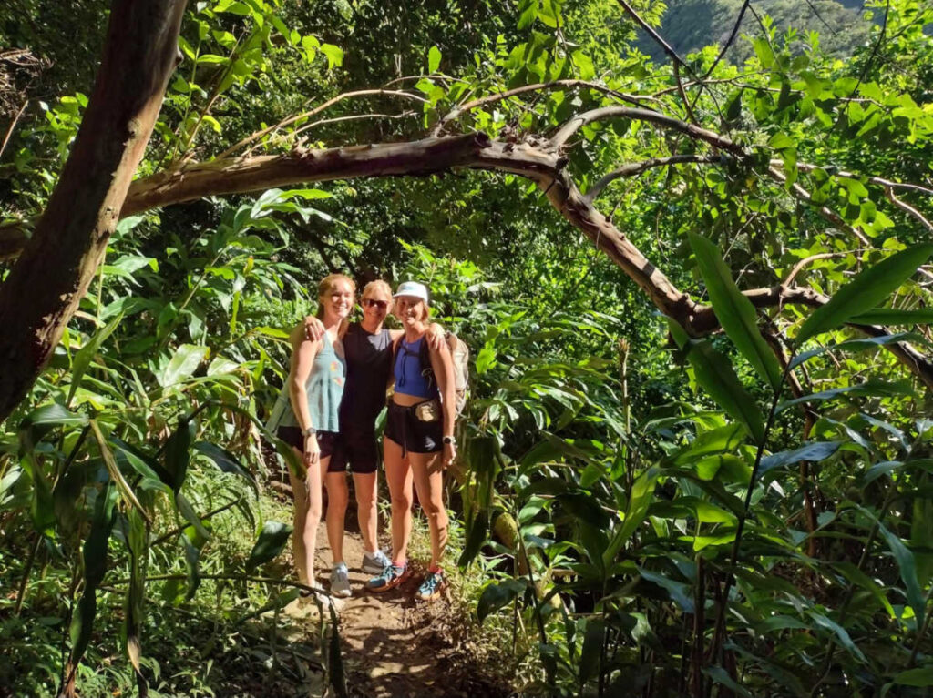 The author Rebecca Parsons with her friends hiking at the tropical jungle