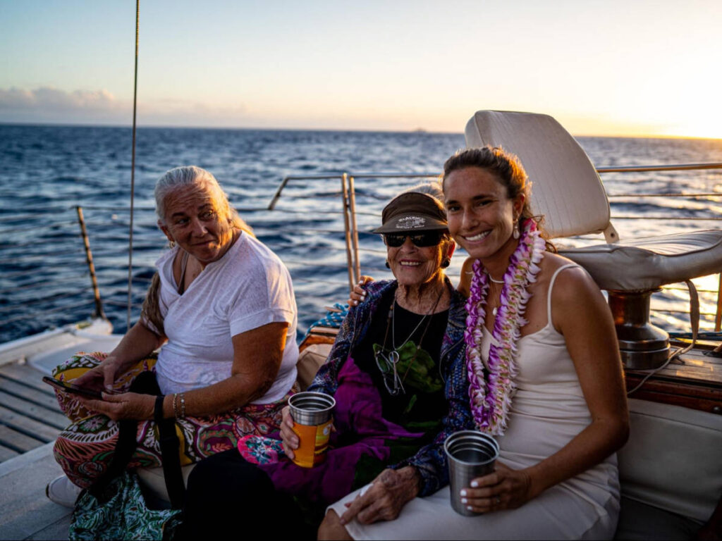 The author Rebecca Parsons with friends enjoying and drinking on the boat at Sunset